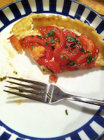 a slice of tarte tomate a la moutarde on a plate